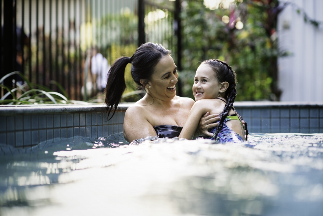 Mum swimming in the pool with daughter
